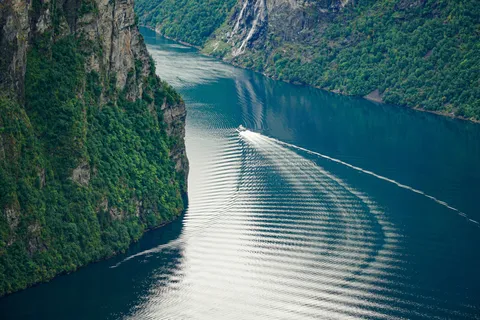 Cruiseskip i norsk fjord sett ovenfra